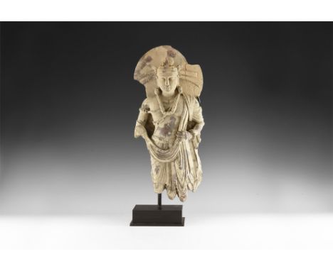 2nd-4th century AD. A schist statue of Maitreya standing, hair arranged in a bun at the front of the head, diadem with knotte