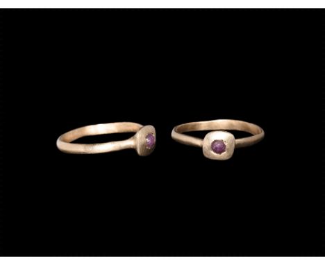 13th-14th century AD. A gold band ring with square-shaped bezel set with a cabochon ruby.  2.21 grams, 19.78mm overall, 18.81