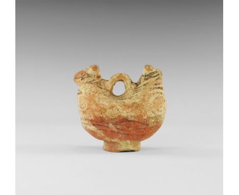 8th-10th century AD. A ceramic flask formed as a pair of addorsed animals with strap handle between, flared base, hole to the