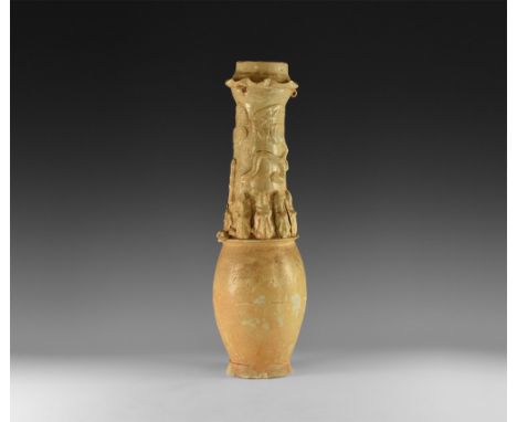 Song Dynasty, 960-1127 AD. A cream-glazed ceramic granary jar with rosette appliqués and undulating dragon to the neck above 