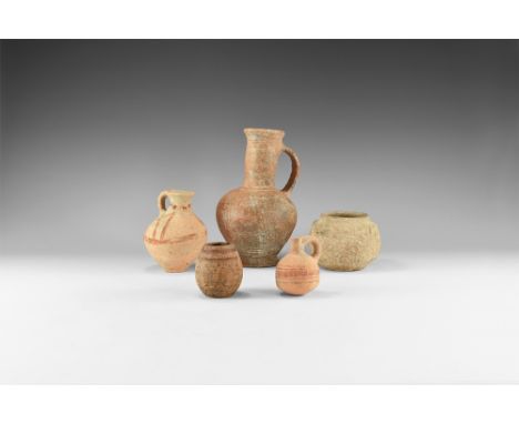 2nd-1st millennium BC. A mixed ceramic group comprising: a jug with flared base and rim, bulbous body, strap handle; a squat 