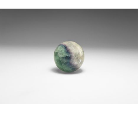 A polished fluorite sphere of white, purple, and green fluorite. See Bonewitz, Dr. Ronald Louis, Rocks & Minerals, 2008, p.17