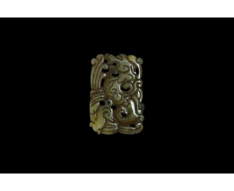 Han Dynasty, 206 BC-220 AD. A bifacial rectangular openwork jade pendant with a pixiu among foliage.  23 grams, 56mm (2 1/4")