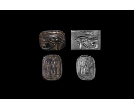 Late Period, 664-332 BC. A carved black jasper amuletic bead with bifacial decoration, to one side a finely carved wedjat, to