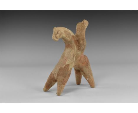 5th-4th century BC. A ceramic figure of a male with finely detailed facial features wearing peaked cap, bands of curly hair a
