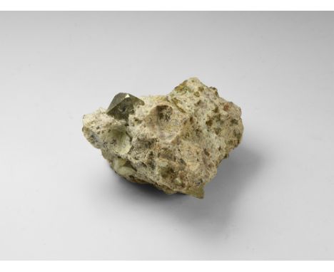 A fine octahedral crystal of pyrite in matrix, the crystal points with pyritohedral tips, and with several cubo-octahedral cr
