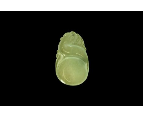 20th century AD. A flat-section jade pendant of a serpentine creature, pierced for suspension.  15 grams, 46mm (2"). From an 