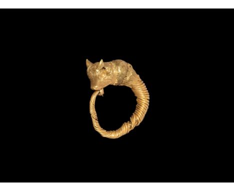 Ptolemaic Period, 305-30 BC. A gold earring with expanding shank of coiled gold wire, bulb with filigree detail and bull-head