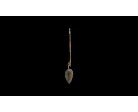 1st-2nd century AD. A silver ligula with piriform bowl, openwork scroll to the neck, balustered shank with ribbed knop finial