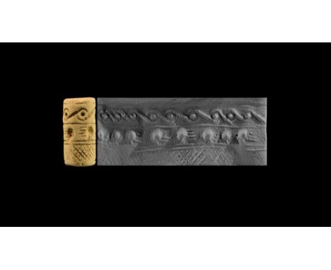15th-13th century BC. A ceramic cylinder seal with three lines of decoration; accompanied by an old scholarly note, typed and