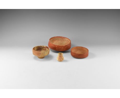 1st-3rd century AD. A mixed ceramic vessel group comprising: two samian ware bowls each with rounded underside; a terracotta 