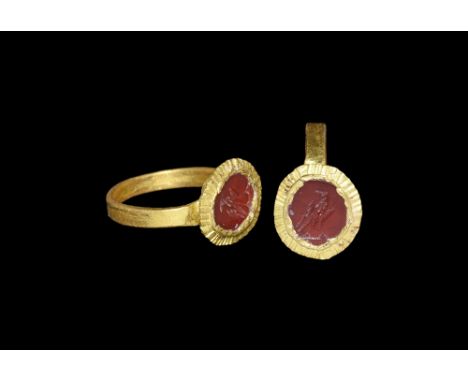 3rd century AD. A flat-section gold hoop with discoid bezel, crimped flange and inset carnelian plaque with intaglio regardan