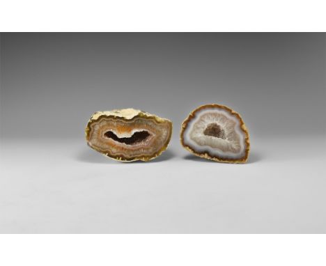 A group of two agate geodes, comprised of numerous vari-coloured agate bands, and filled with quartz crystals. See Bonewitz, 