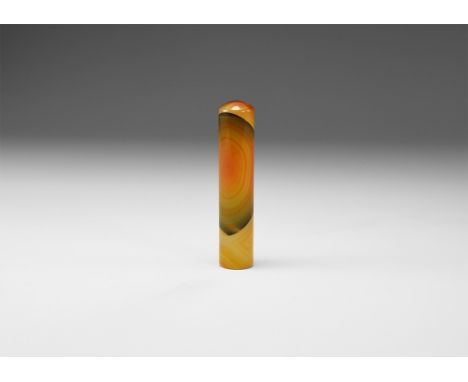 A 15mm diameter cylinder of polished banded agate with bands in varying shades of orange, black, and red, rounded at one end,