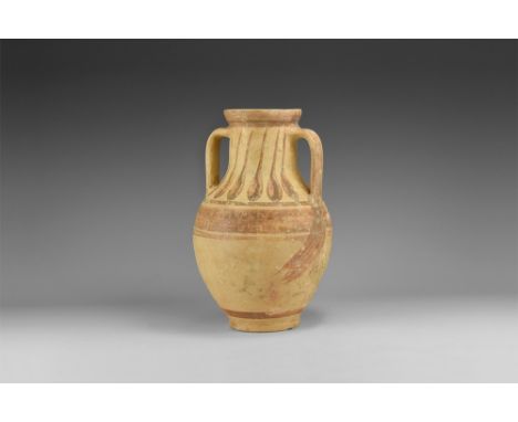 2nd millennium BC. A tall ceramic jar or vase with basal ring, gently sloping shoulder, broad neck, chamfered everted rim, tw