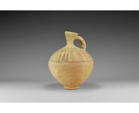 2nd millennium BC. A biconvex ceramic jar with basal ring, broad shoulder, flared scaphoid-section neck, strap handle with tw