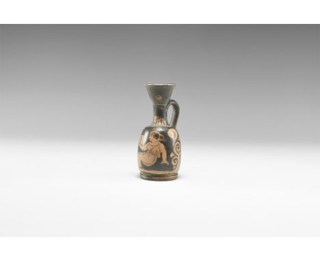 5th-3rd century BC. A ceramic blackware lekythos with barrel-shaped body, trumpet-shaped neck and mouth, inturned rim, strap 