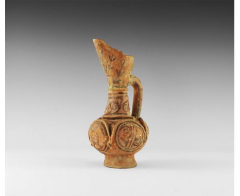 8th-10th century AD. A ceramic ewer with flared base bulbous body, bell-shaped shoulder, funicular mouth with extended pourin