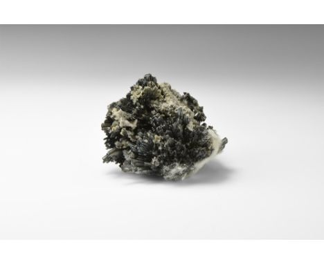A matrix specimen of radiating stibnite groups, in white card tray. See Bonewitz, Dr. Ronald Louis, Rocks & Minerals, 2008, p