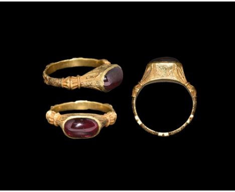 13th-14th century AD. A D-section gold hoop with balustered shoulders, rosette plaques and scrolled detailing; elliptical bez