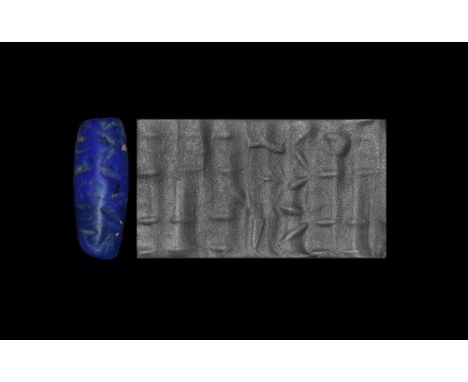 Circa 3000 BC. A lapis lazuli cylinder seal with figure and animals; accompanied by an old scholarly note, typed and signed b