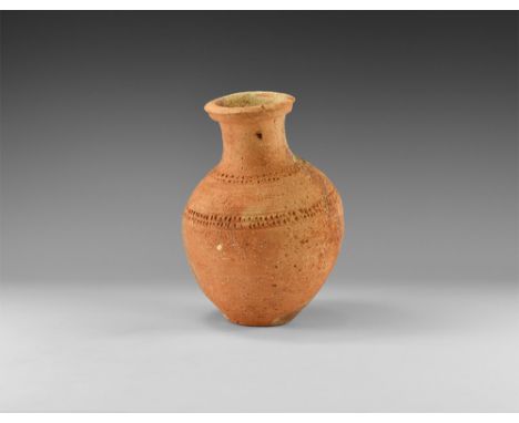 3rd millennium BC. A ceramic bottle with bulbous body, broad neck, tiered rim, bands of rouletting to the shoulder and neck. 