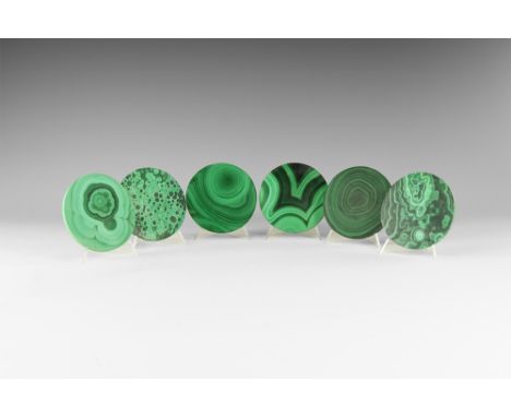 A group of six cut and polished circular malachite coasters with pale and dark green banding. See Bonewitz, Dr. Ronald Louis,