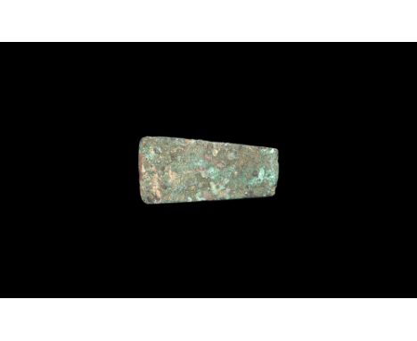 2nd millennium BC. A trapezoidal copper flat axe with chamfer to one face, straight edge.  214 grams, 87mm (3 1/2"). From a G