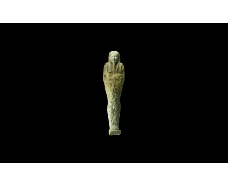 Late Period, 30th Dynasty, 380-343 BC. A large blue-green glazed composition shabti with finely modelled facial features, tri