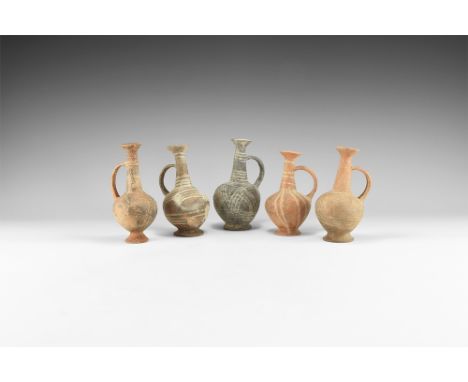2nd millennium BC. A group of five ceramic vessels, each with bulbous body, flared base, tapering neck, flared rim, strap han