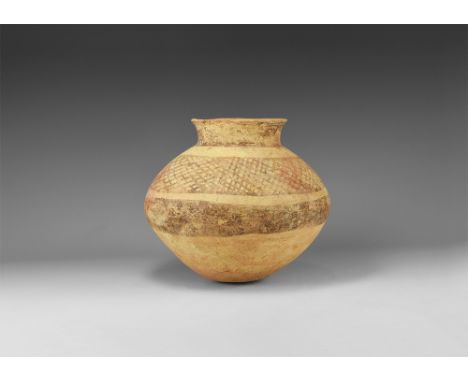2nd millennium BC. A biconvex ceramic jar with flat base, low neck, everted rim; concentric painted bands to neck and shoulde