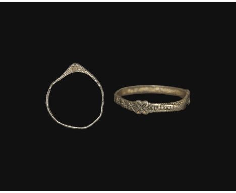 13th century AD. A flat-section silver hoop with triangular-section bezel, band of impressed starburst motifs to the outer fa
