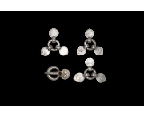 5th century AD. A group of silver belt fittings comprising: a buckle with round-section loop, tapering tongue with hooked end