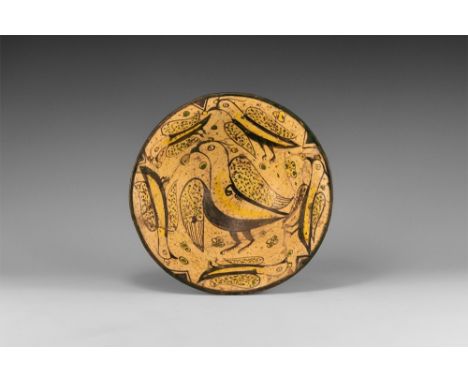 10th-12th century AD. A bell-shaped ceramic bowl with cream glaze, basal ring, scene to the inner face of a frieze of advanci