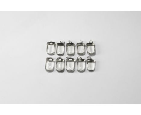 A group of ten polished rock crystal quartz polished pendants with silver-coloured metal caps. See Bonewitz, Dr. Ronald Louis