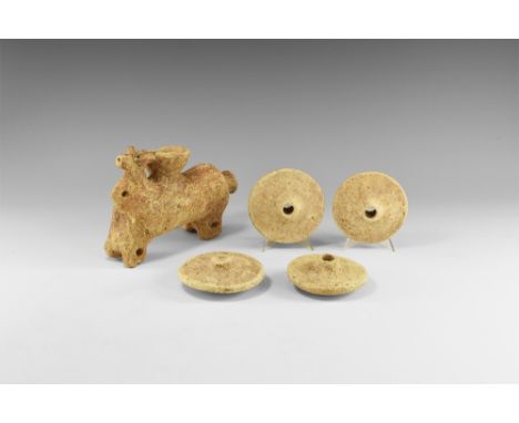 1st millennium BC. A hollow-formed ceramic vessel with bovine head to the forward end and pierced lug to the chest, bowl to t