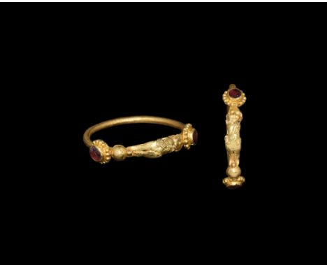 3rd-2nd century BC. A gold hoop ring with figure of a child with hands on hips, sash across chest with granule decoration, st