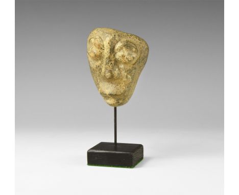 Pliocene Period, 5.2-2.5 million years BP. A mastodon fossil bone carving from Java, on stand.  178 grams, 13.5cm (5 1/4"). F