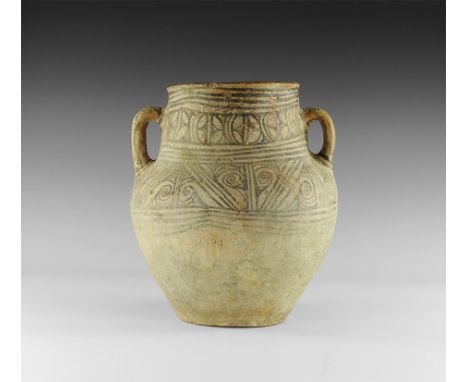 8th-10th century AD. A large white ceramic jar with piriform body, wide neck and everted rim, two strap handles to the should