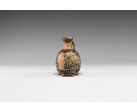 5th-3rd century AD. A ceramic blackware lekythos with flared base, barrel-shaped body, trumpet-shaped neck, strap handle to t