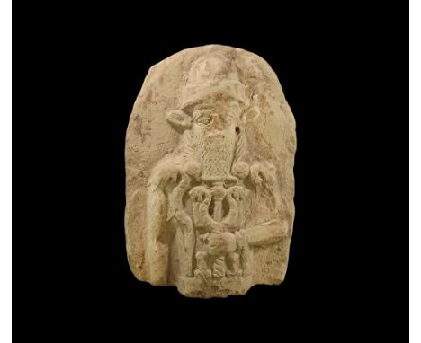 18th-17th century BC. A D-shaped baked clay plaque fragment with high-relief figure of a standing god Nergal wearing tall cap