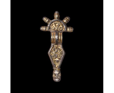 6th century AD. A silver-gilt radiate-headed bow brooch comprising a D-shaped headplate with five radiating collared knops, s