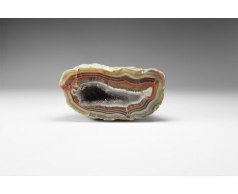 A stunning natural banded agate geode half with multi-coloured bands, filled with lilac amethyst. See Bonewitz, Dr. Ronald Lo