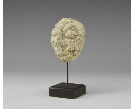 Pliocene Period, 5.2-2.5 million years BP. A mastodon fossil bone carving from Island of Java, with stand.  160 grams, 13cm i