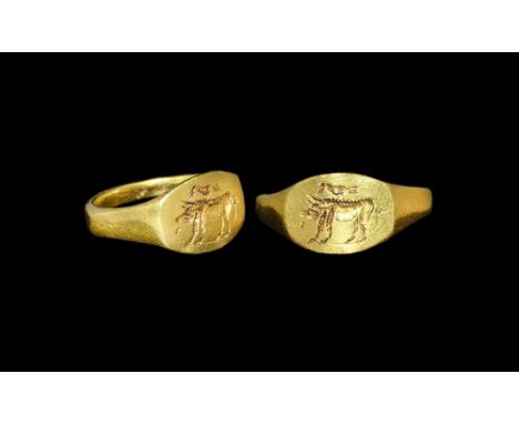3rd century AD. A substantial square-section gold hoop with keeled shoulders, discoid plaque with intaglio design of an advan