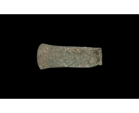 1st millennium BC. A substantial flat-axe with ovoid socket, flared blade with curved edge.  1.1 kg, 17cm (6 3/4"). From a Ge