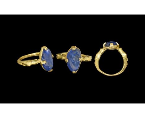 12th-13th century AD. A D-section gold hoop with shoulders formed as opposed dragon heads supporting an elliptical plaque wit