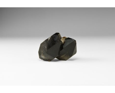 A conjoined pair of double-terminated black smoky quartz (morion) crystals, in white card tray with label reading: 'SMOKY QUA