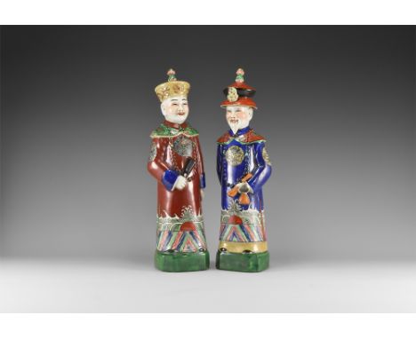 20th century AD. A group of two porcelain figures consisting: one in a maroon robe with green collar and hem, blue sleeve col