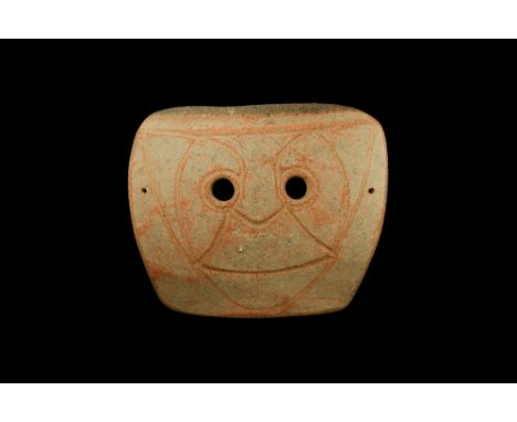 4th-3rd century BC. A large rectangular-shaped slightly curved ceramic mask with two eye-holes and incised stylised facial de